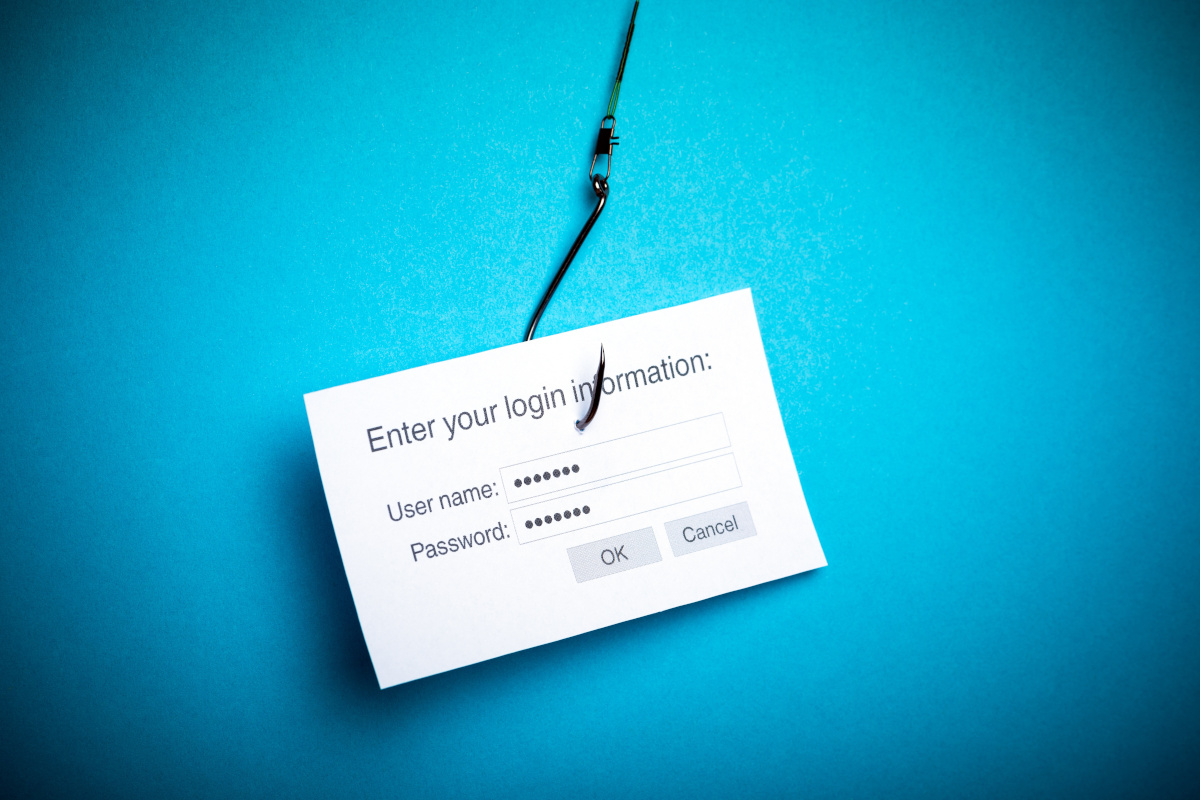 Representation of phishing attempt with hook and piece of paper